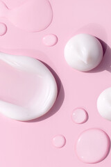 composition of smears of cream texture on a pink background