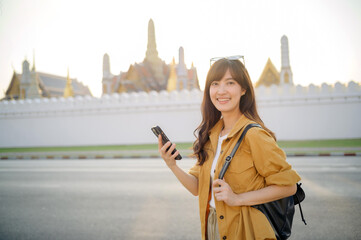 Traveler asian woman in her 30s using smartphone for navigation destination on the urban street at Bangkok, Thailand. - 792478184