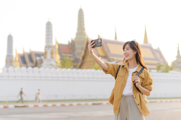 Traveler asian woman in her 30s explores the Grand Palace with a local guide. Uncover hidden gems and immerse yourself in Thai culture with her adventure. - 792478190