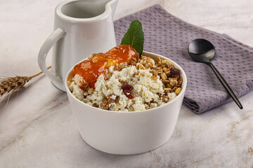 Curd with granola and orange jam