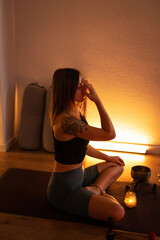 Meditation and breathing during yoga classes. The girl holds her fingers on her forehead and...