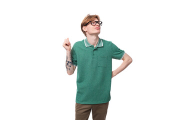 young dreaming european guy with red hair in glasses raised his head up and thinks