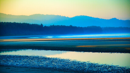 A beautiful blue ocean with a mountain in the background