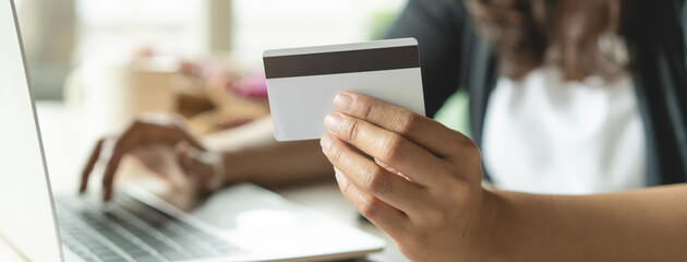 close up shots hands of person shopping on ecommerce and using credit card payment via online...