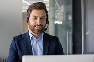 Professional man with headset working at modern office