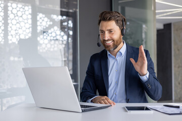 Smiling businessman with headset during a video call