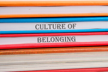 Culture of belonging symbol on notebooks stacked in a pile - obrazy, fototapety, plakaty