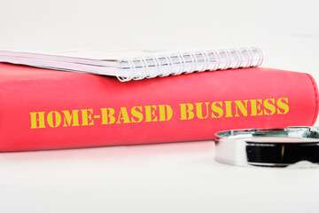 Text Home based business on the back of the book cover, a notebook on a white background - obrazy, fototapety, plakaty