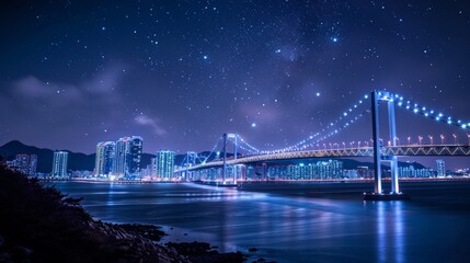 With the stars twinkling overhead, Gwangan Bridge emerges as a striking silhouette against the Busan skyline, its illuminated arches casting a magical spell over the coastal cityscape of South Korea. - obrazy, fototapety, plakaty