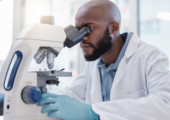 Black man, scientist and microscope in laboratory for science research, data analysis and medical...