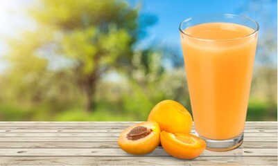 Glass of apricot juice drink on the desk