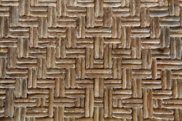 Close up of patterned rattan weaving that is dull and dirty, suitable for backgrounds and tectures.