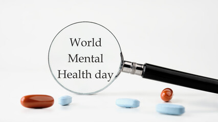 Depression and support concept. World mental health day on a white background through a magnifying glass - obrazy, fototapety, plakaty