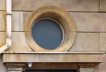 Round Glass Window at Old Building Exterior