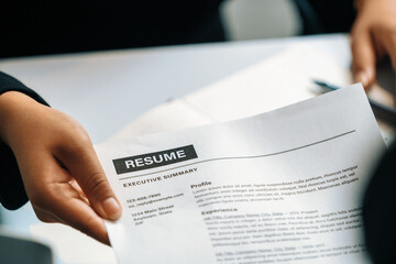 Close up view of employee candidate hands CV resume document to the interviewer HR human resources...