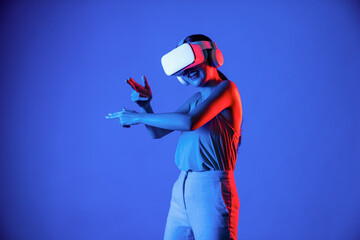 Smart female standing wearing VR headset connecting metaverse, future cyberspace community...