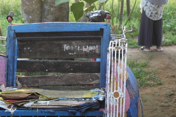 Close up of old and broken rickshaw with blurred background. suitable for old school transportation theme.