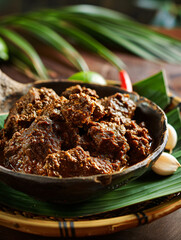 Rendang on wooden plate. Eid Mubarak food. Indonesian/Malaysian beef stew made with beef, spices and coconut milk.