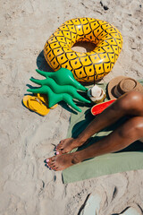 Sunbathe at the beach Women's feet, sandals and fruit