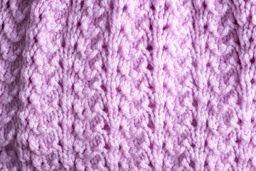 Fragment of hand knitted fabric light lilac. beautiful pattern