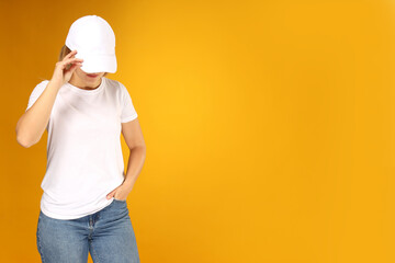 A young woman in a white T-shirt and cap