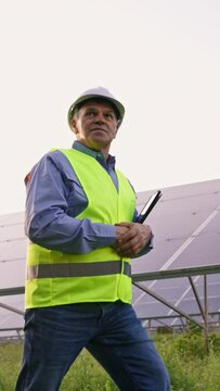 Mature Engineer Man Hand in Solar Panels Industrial Area