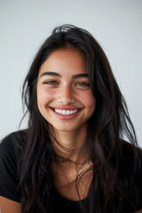 Naklejka premium A woman with long hair is smiling while wearing a black shirt