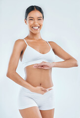 Body, digestion and hands on stomach for woman in studio, nutrition and gut health on white...
