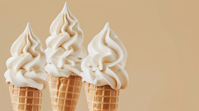 Three vanilla soft serve ice creams in waffle cones on a beige background