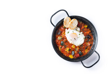 Vegetable pisto manchego with tomatoes, zucchini, peppers, onions,eggplant and egg, served in frying pan isolated on white background. Top view. Copy space - 792589907