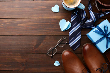 Father's Day themed flat lay with presents, a blue card, love hearts, and fashionable men's...