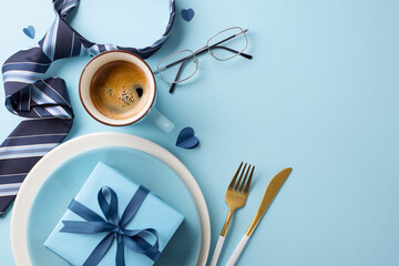 Elegant Father's Day table setting with a necktie, coffee, glasses, and gift on a blue background