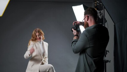 Model young woman preparing posing for photo taken with professional photographer in studio on fashion concept