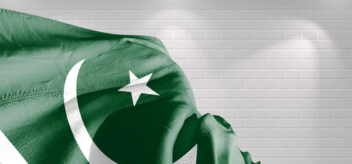 Pakistan national flag cloth fabric waving on beautiful bricks Background.	
