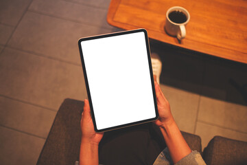 Top view mockup image of a woman holding digital tablet with blank white desktop screen in cafe - 792602159