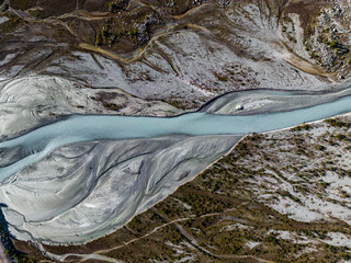 High-resolution aerial snapshot showcasing a sinuous mountain river carving through a textured landscape with varied terrain