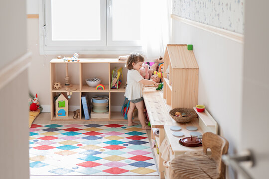 Young girl playing in a brightly colored playroom