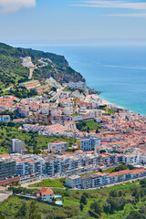 aerial view over city of Sesimbra with atlantic ocean in background