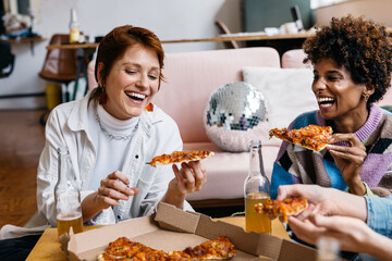 Colleagues enjoying a pizza break in a cozy co-working space