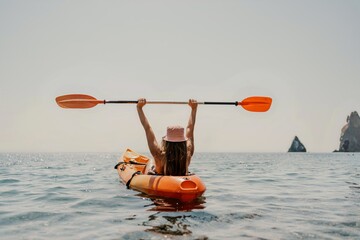 Kayak sea woman. Happy attractive woman with long hair in red swimsuit, swimming on kayak. Summer...