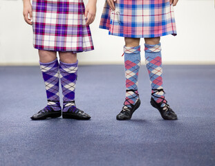 Two young Highland dancers getting ready for dance.