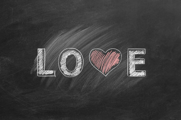 LOVE word with heart shape hand drawn on blackboard. Valentines day, love, compassion concept.