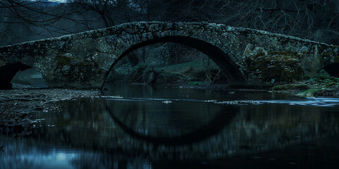 stone bridge at the night. under exposure photo. medieval concept. - obrazy, fototapety, plakaty