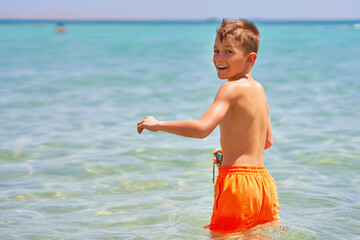 Photo of relaxing vacation in Egypt Hurghada boy entering water - 792628539