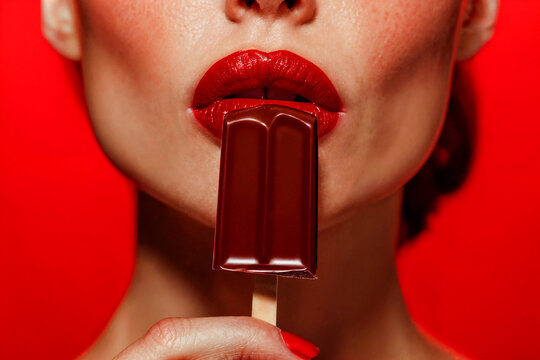Woman holding chocolate bar with red lipstick. Generative AI