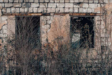 empty windows of a damaged house in Ukraine