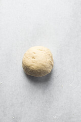 Fototapeta na wymiar Overhead view of egg noodles dough a marble countertop, homemade egg noodles and egg pasta dough ball