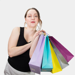 Cheerful woman holding colored shopping bags in ruah. High quality photo