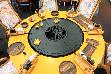 Round dining table with round grill inside