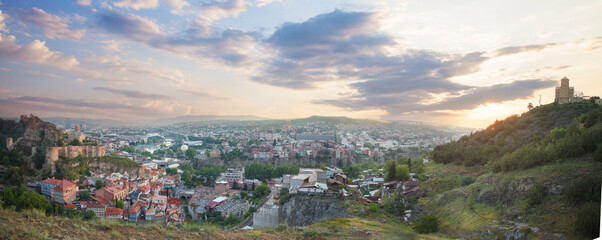 Panorama landscape of old Tbilisi on the background of spectacular blue sky with clouds